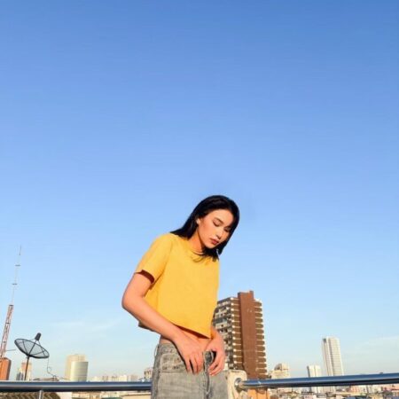 Female model with Oversized Crop Top Mustard T-shirt.