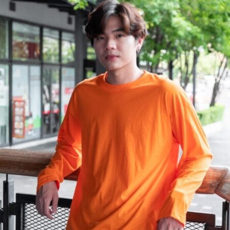 Male model with Oversized Long Sleeves Pumpkin Orange T-shirt.