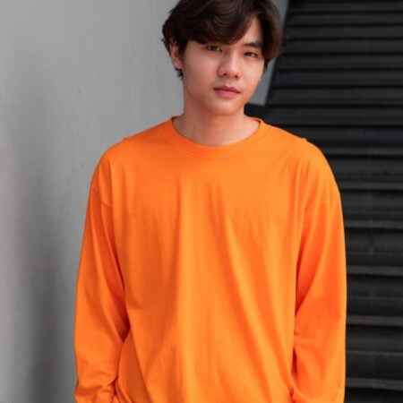 Male model with Oversized Long Sleeves Pumpkin Orange T-shirt.