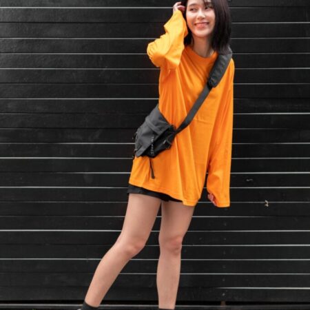 Female model with oversized long sleeves Pumpkin Orange T-shirt.