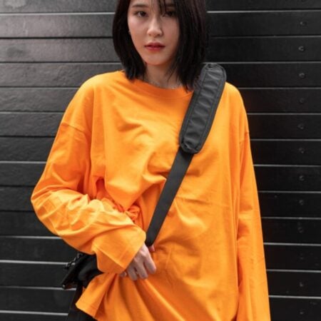Female model with oversized long sleeves Pumpkin Orange T-shirt.
