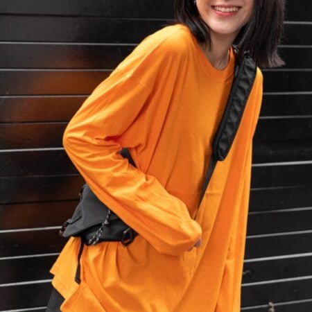 Female model with oversized long sleeves Pumpkin Orange T-shirt.