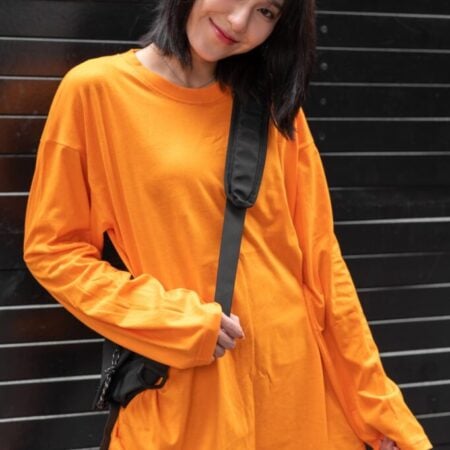 Female model with oversized long sleeves Pumpkin Orange T-shirt.