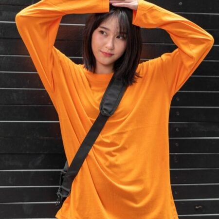 Female model with oversized long sleeves Pumpkin Orange T-shirt.