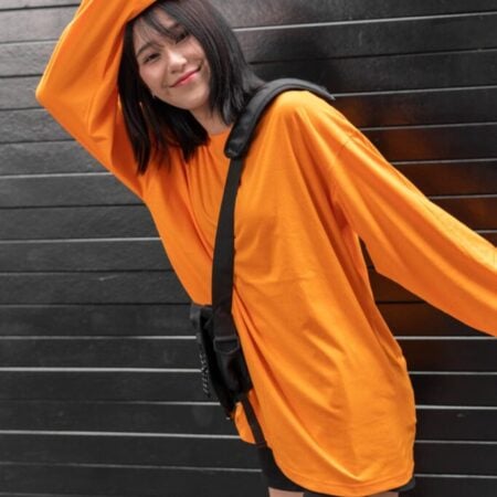 Female model with oversized long sleeves Pumpkin Orange T-shirt.