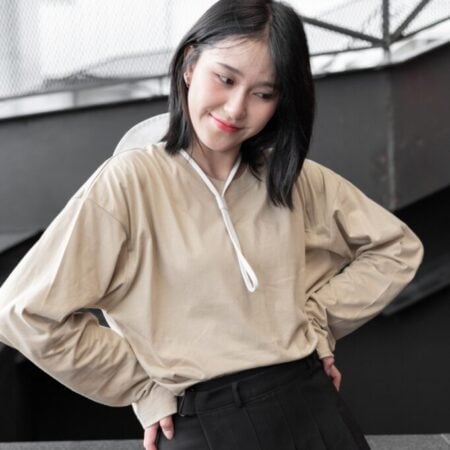 Female model with oversized long sleeves Beige T-shirt.