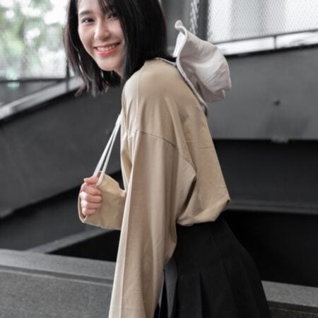 Female model with oversized long sleeves Beige T-shirt.