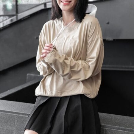 Female model with oversized long sleeves Beige T-shirt.