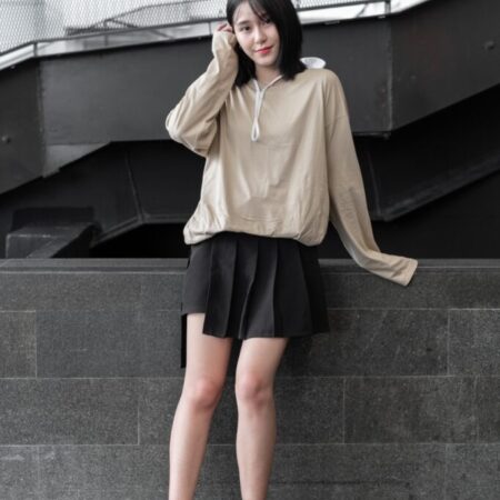 Female model with oversized long sleeves Beige T-shirt.