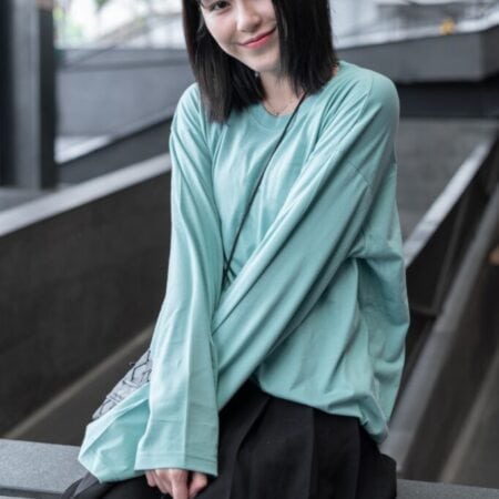 Female model with oversized long sleeves Pastel Green T-shirt.