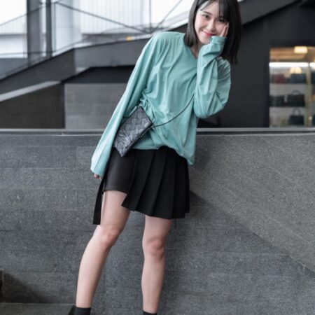 Female model with oversized long sleeves Pastel Green T-shirt.