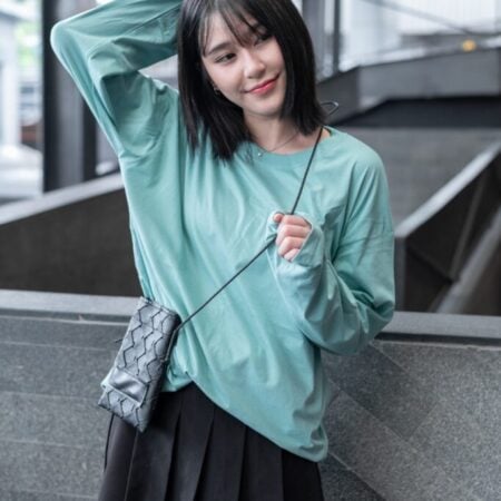 Female model with oversized long sleeves Pastel Green T-shirt.