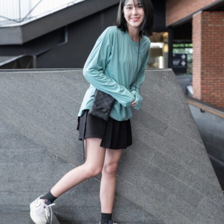Female model with oversized long sleeves Pastel Green T-shirt.