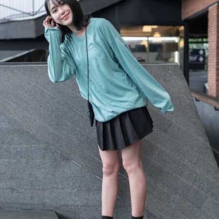Female model with oversized long sleeves Pastel Green T-shirt.