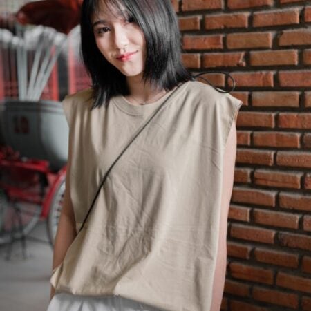 Female model with Oversized Tank Top Beige T-shirt.